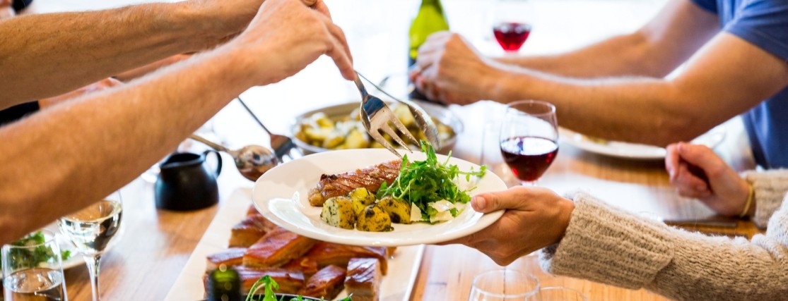 plates of food being shared across a dining table