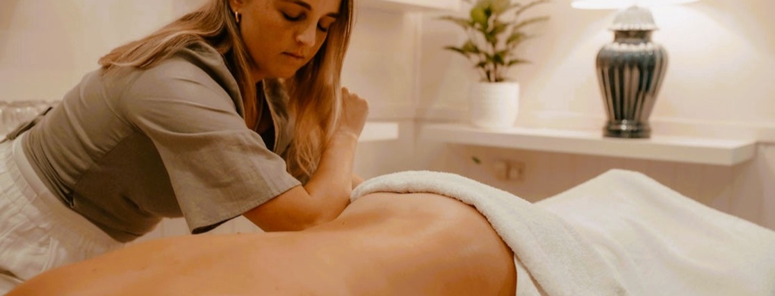 a person lying face down receiving a relaxing massage