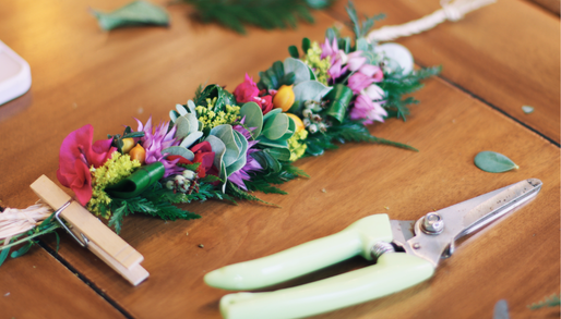 a handcrafted hawaiian floral lei and a pair of scissors