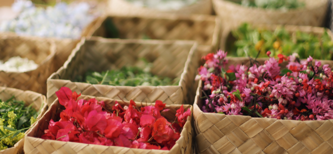 A group of people wearing traditional Hawaiian lei's that they have hand made