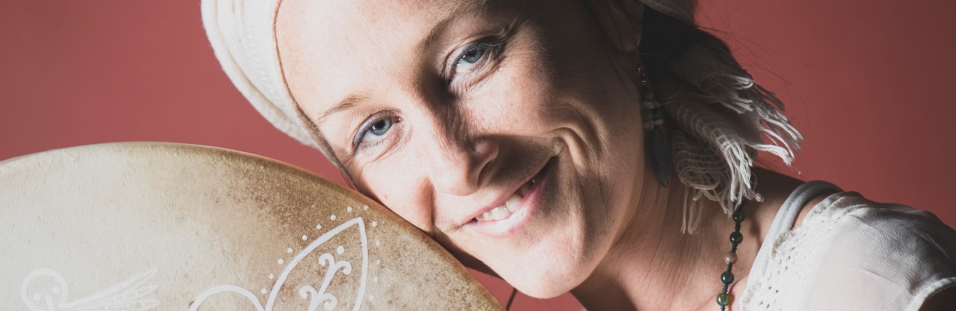a woman in a turban with her shamanic drum