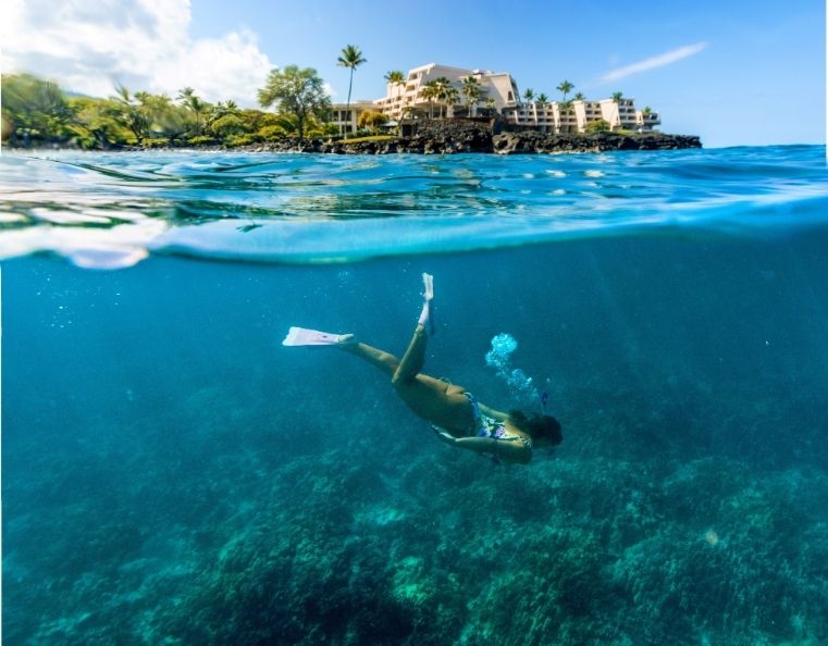 a woman snorkelling in a bay on the Kona coast of Hawaii