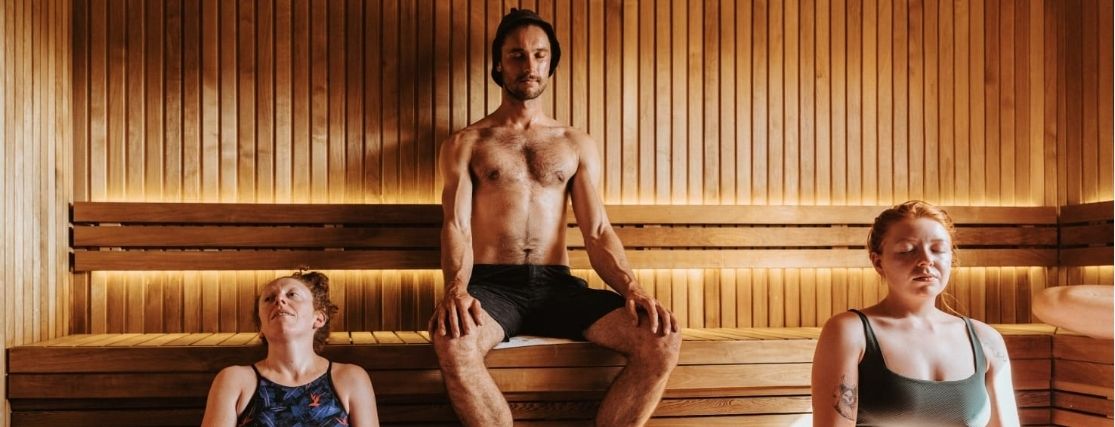 a group of people sitting in a traditional sauna