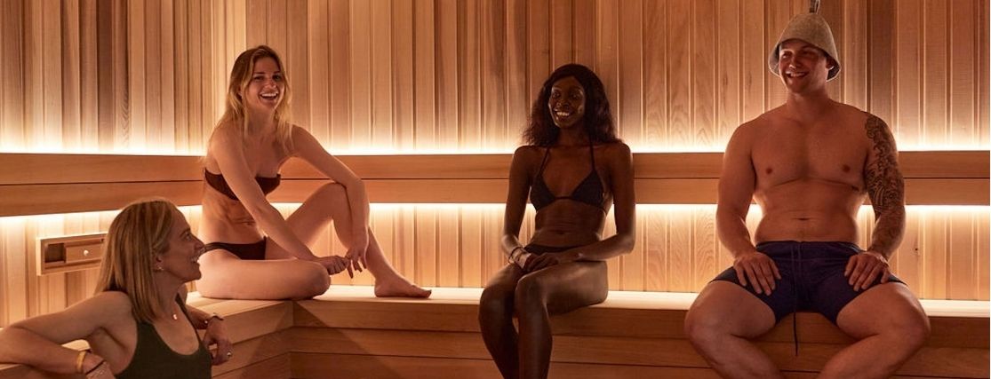 a group of people sitting in a sauna