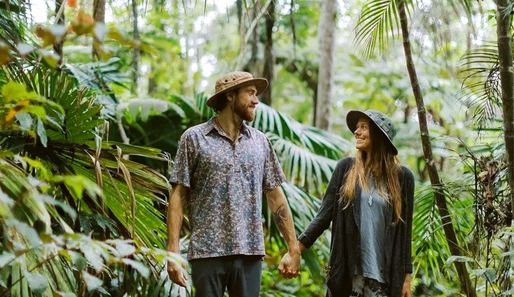 a couple walking through a cloud forest in Hawaii