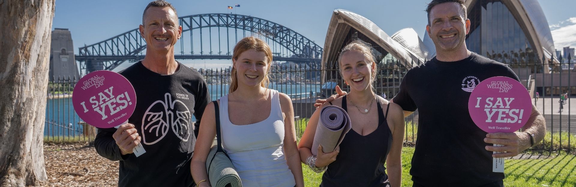 2 women and 2 men with yoga mats in front of the Sydney Opera House and Harbour Bridge for Global Wellness Day 2026