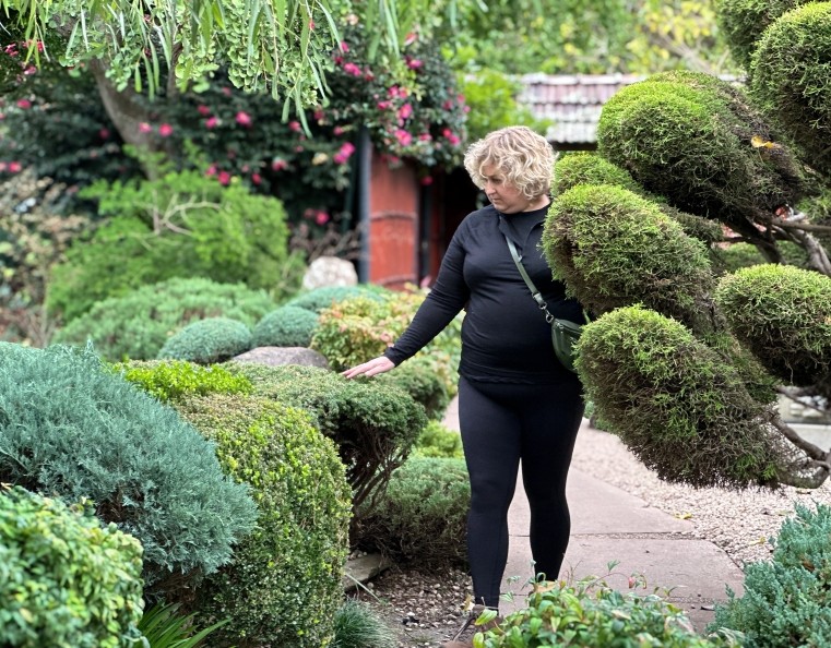 A lady in black walking through Himeji Japanese Gardens in Adelaide