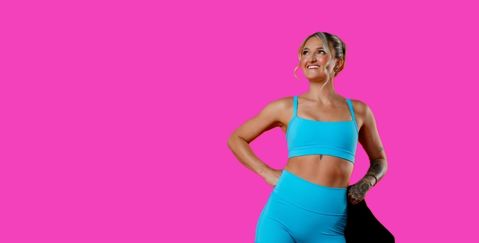 Mental health advocate Brook Mcintosh in bright blue active wear against a pink background