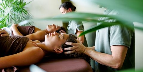A couple having a massage in a tropical day spa