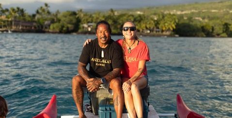 Iko and Holly from Anelakai Adventures sitting on an outrigger canoe