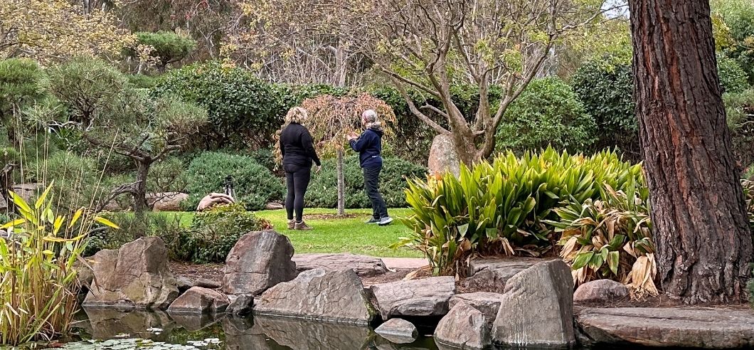 A lady in black walking through Himeji Japanese Gardens in Adelaide