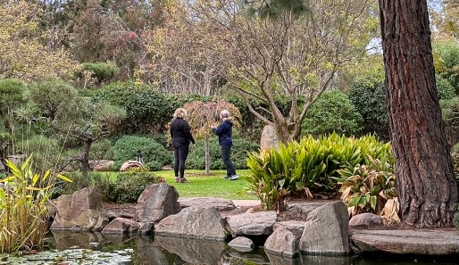 Two women in black walking in Himeji Japanese Gardens, Adelaide