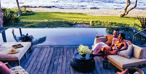 a couple relaxing at their villa at Four Seasons Resort Hualalai