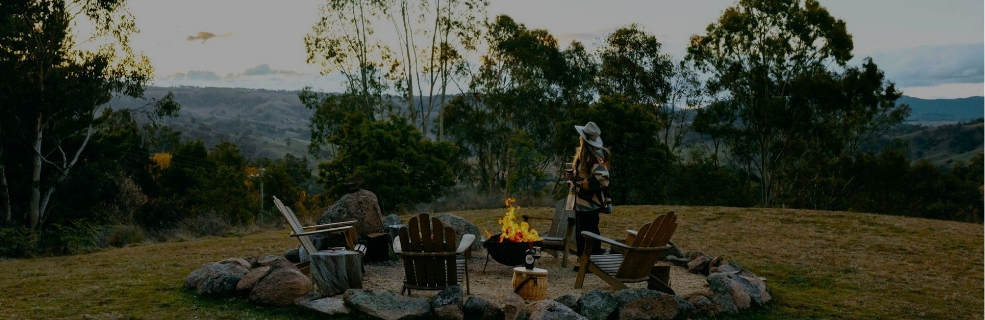a woman near a fire pit on a paddock in the NSW Blue Mountains