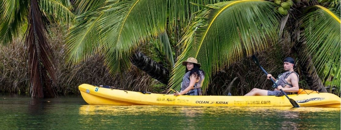 a couple kayaking in a river in Hawaii