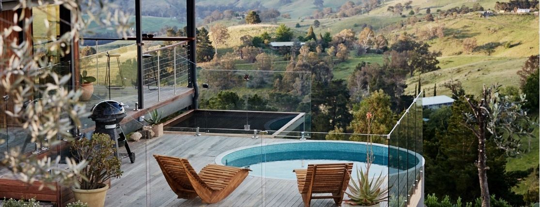 a round plunge pool and 2 lounge chairs overlooking the NSW blue mountains